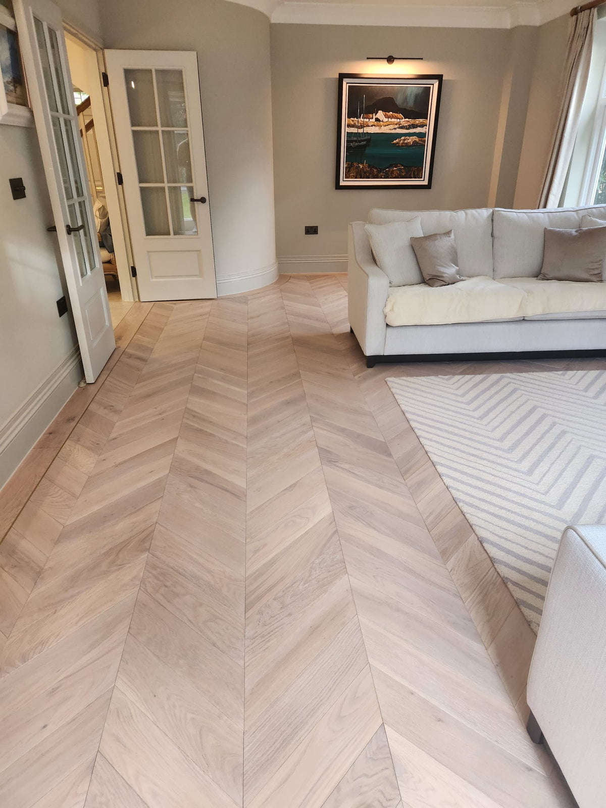 The finished chevron room looking towards the curved wall and the hall doors