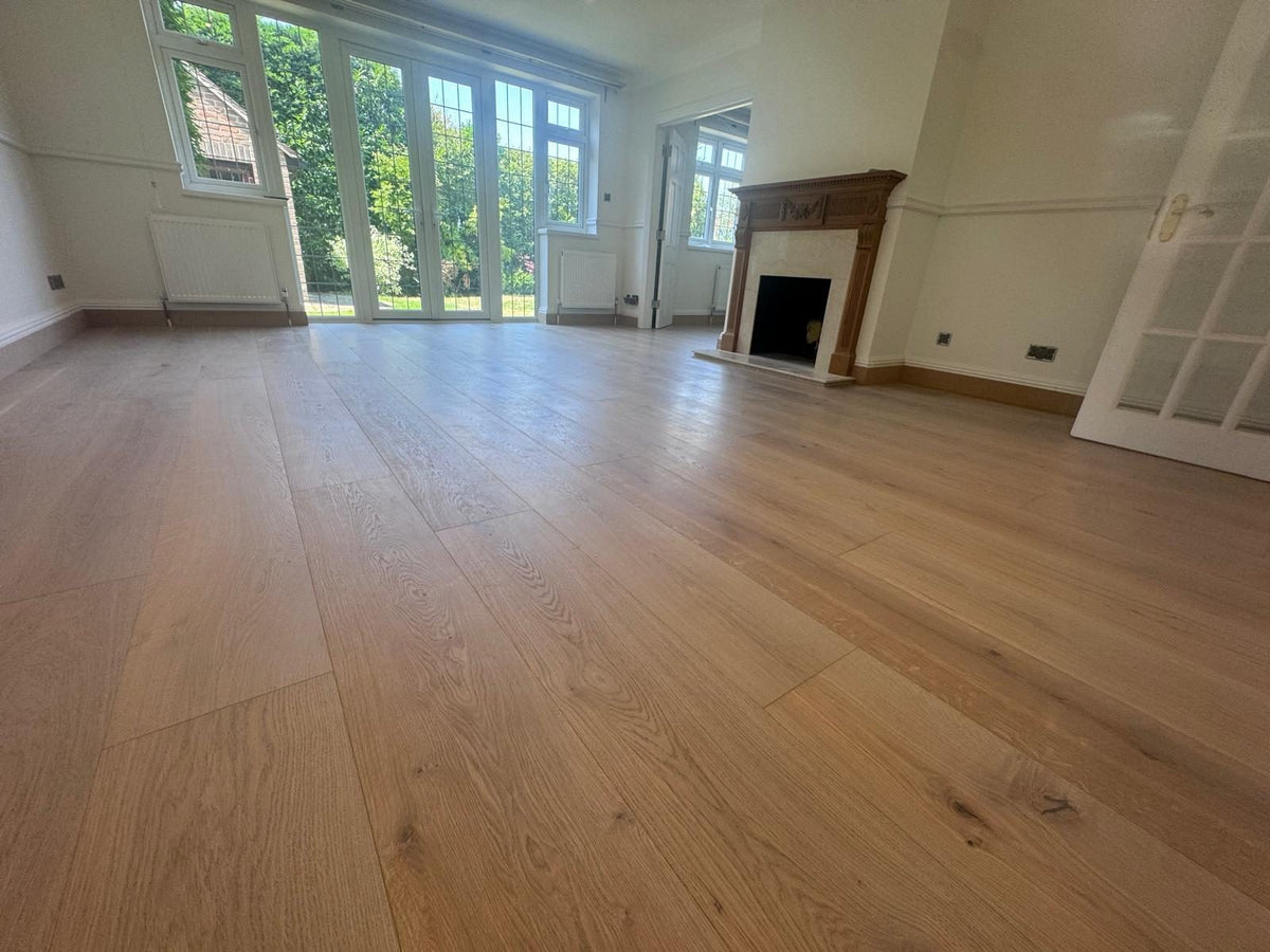 The finished room with garden doors, a fireplace with a timber surround, and glazed double doors to the right
