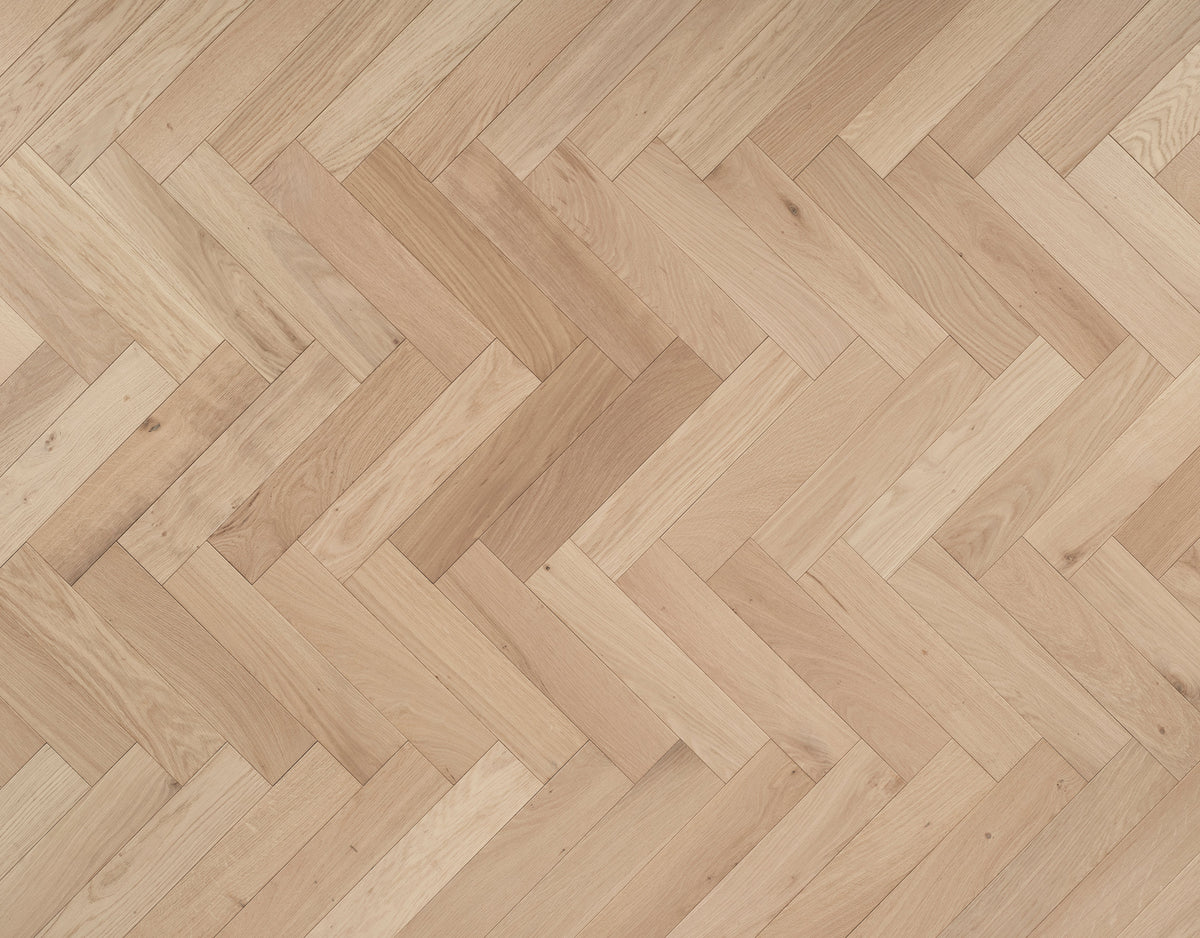 Shore Drift Oak herringbone — brushed and invisible-lacquered oak parquet block