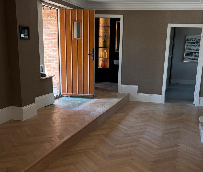 The finished hall in herringbone, running up to the raised entrance and the open front door